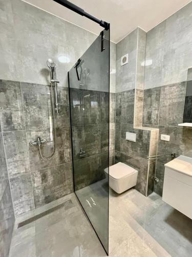 a bathroom with a shower and a toilet and a sink at Villa Ivana in Peroj