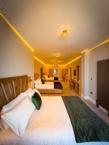 a large bedroom with two beds in a room at Emerald Tide Hotel - Blackpool in Blackpool