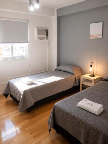 a bedroom with two beds and a window at Aires Express in Buenos Aires