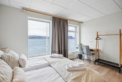 a bedroom with a bed and a large window at Hotel West in Patreksfjörður