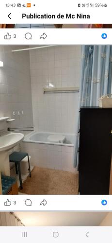 a bathroom with a bath tub and a sink at Lagunabeach Knokke-Heist in Knokke-Heist