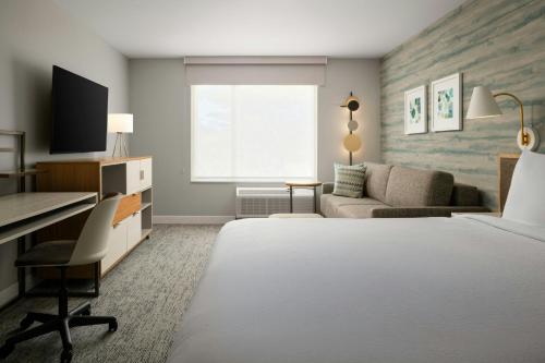 a hotel room with a bed and a desk at TownePlace Suites by Marriott Seekonk in Seekonk