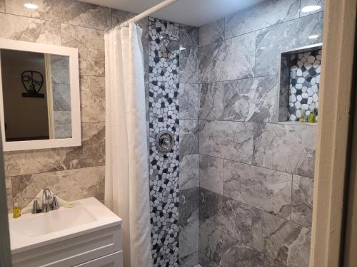 a bathroom with a sink and a shower at Desert Hills Motel in Las Vegas