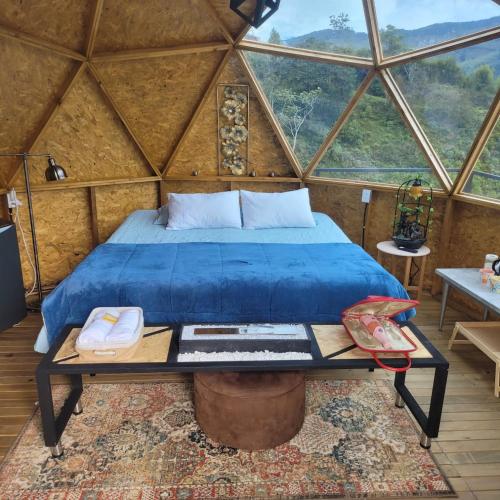 a bed in a room in a yurt at Hotel Deluxe Glamping in Guatapé