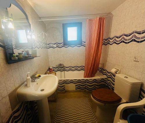 a bathroom with a sink and a toilet and a tub at Second Home Ierissos in Ierissos