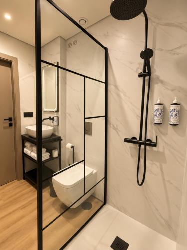 a bathroom with a toilet and a sink at INOTEL Paços de Ferreira in Paços de Ferreira