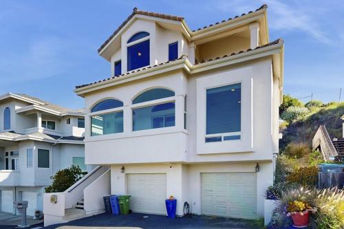 a large white house with two garage at Park Avenue Beach Life in Cayucos