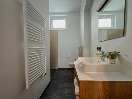 a white bathroom with a sink and a mirror at Bockblick Top 4 in Weisspriach