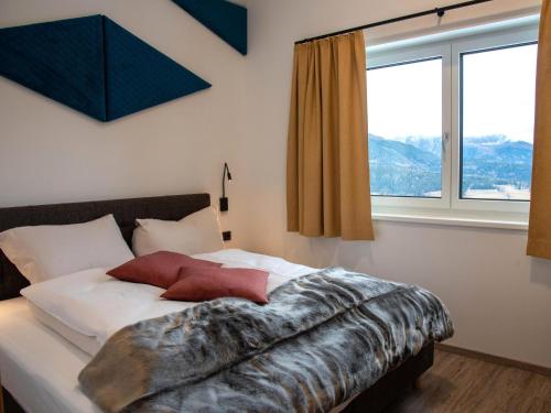 a bedroom with a bed with a large window at Bockblick Top 4 in Weisspriach