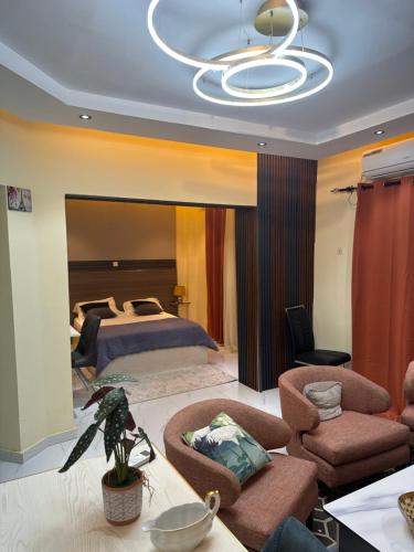 a large bedroom with a bed and a chandelier at Residence MBK Studio 1 in Ziguinchor