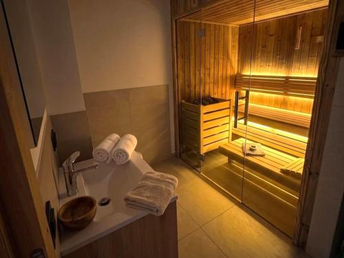 a bathroom with a sink and a glass shower at Grebenzen 66 in Sankt Lambrecht