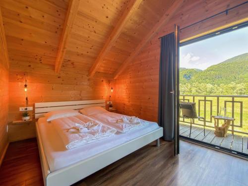 a bedroom with a bed and a large window at Rattendorf 23B in Rattendorf