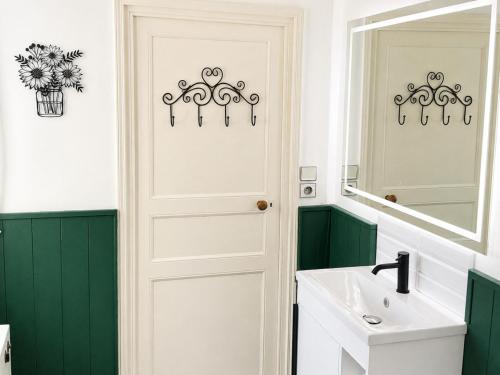 a bathroom with a white door and a sink at Petit Vingne in Édon