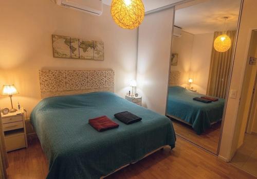 a bedroom with two beds and a large mirror at Casa Valdés in Puerto Pirámides