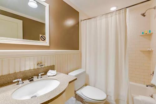a bathroom with a sink and a toilet and a mirror at Southampton Long Island Hotel in Southampton
