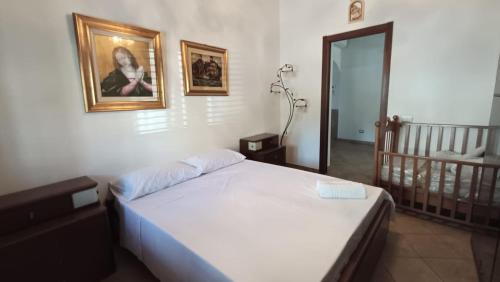 a bedroom with a bed and a picture on the wall at La Dimora di Gianna in Palermo