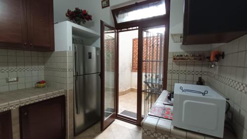 a kitchen with a stainless steel refrigerator and a window at La Dimora di Gianna in Palermo