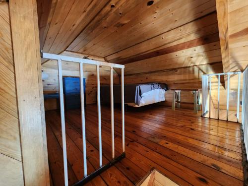 a room with a bed in a wooden cabin at Beaver Creek Guest Ranch in Blue