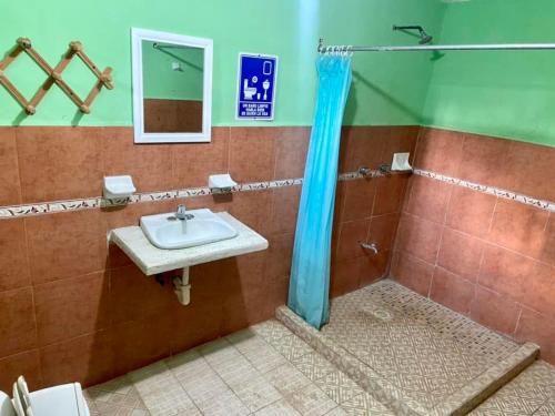 a bathroom with a sink and a shower at HotelMariaAngela in Dzuiché
