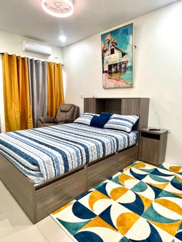 a bedroom with a bed and a chair and a rug at Suite Seven in Mount Pleasant