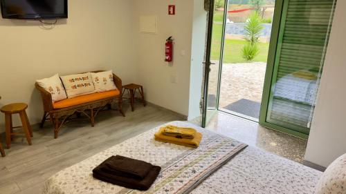a room with a couch and a sliding glass door at Quinta dos Caseiros do Paço de Giela in Arcos de Valdevez