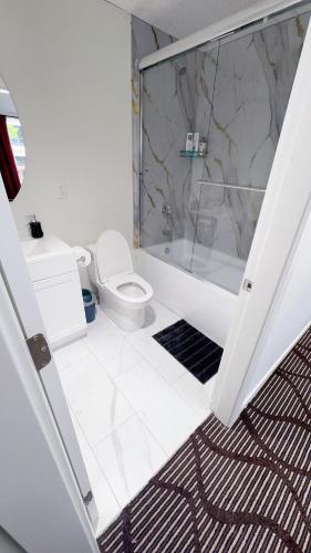 a bathroom with a toilet and a glass shower at Entire condo in White Rock, Canada in White Rock