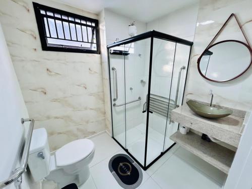 a bathroom with a shower and a toilet and a sink at Lunar Lua Nova 06 in Aracaju