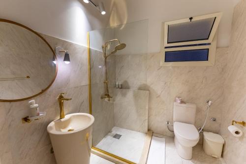 a bathroom with a shower and a toilet and a sink at El Otel Hotel in Cairo