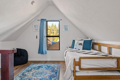 a bedroom with a bed and a window at Bear Sky Cabin in Big Bear City