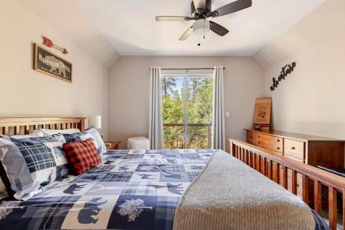 a bedroom with a bed and a ceiling fan at Peaceful Chalet in Oakhurst