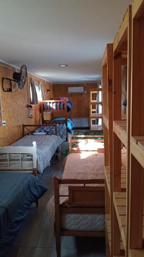 a group of beds in a room with a room with at Vientos de Olavarria -Alquiler temporal in Olavarría