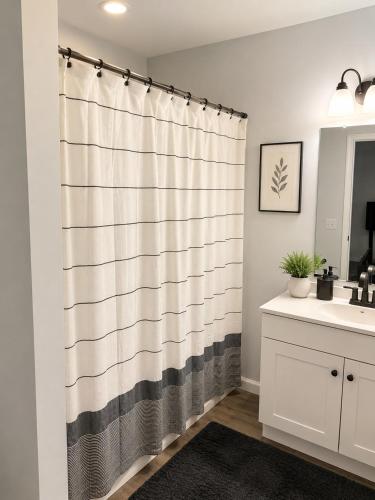 a bathroom with a shower curtain and a sink at Blue Haven Escape in Columbus