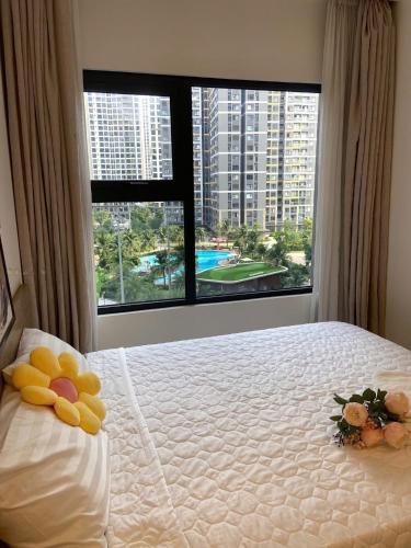 a bedroom with a bed with a large window at Aquar Grand Park in Gò Công