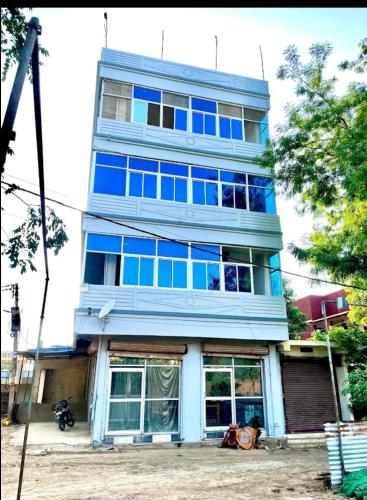 a tall blue building with blue windows at Siddhi palace in Maihar