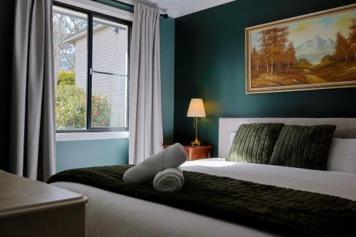 a bedroom with a white bed with a window at La Villa Dolce in Mount Victoria