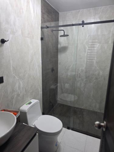 a bathroom with a shower and a toilet and a sink at Verona house in Riobamba