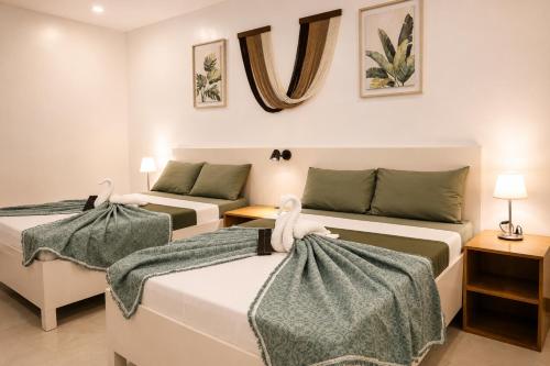 a bedroom with two beds and a couch at Casa Blanca Tanay in Tanay