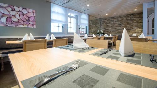 a dining room with a table with a fork and knife at Hotel-Restaurant Ackersand in Ackersand