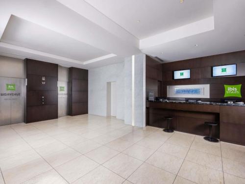 a large lobby with a waiting room with a bar at ibis Styles Tokyo Ginza in Tokyo
