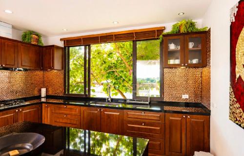 a kitchen with a sink and a window at Casa Nicola Amazing Sea View Villa in Koh Samui in Nathon Bay