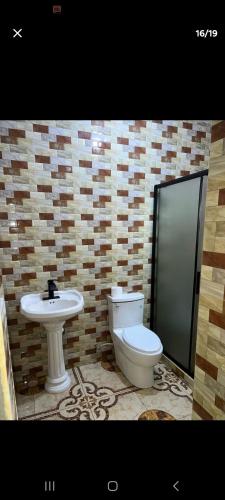 a bathroom with a toilet and a sink at O-t on the rise in Tweedside