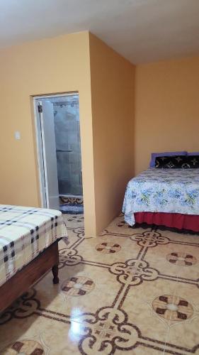 a bedroom with two beds and a rug on the floor at O-t on the rise in Tweedside