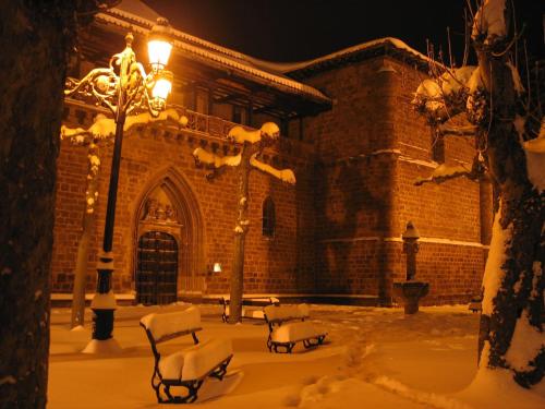 a building with snow covered chairs and a street light at La Cuculla in Ezcaray