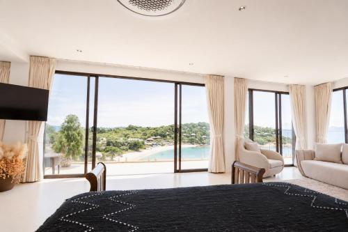 a bedroom with a bed and a view of the ocean at Casa Nicola Amazing Sea View Villa in Koh Samui in Nathon Bay