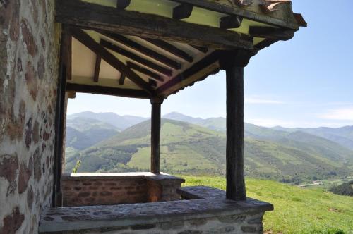 a window on a building with mountains in the background at La Cuculla in Ezcaray