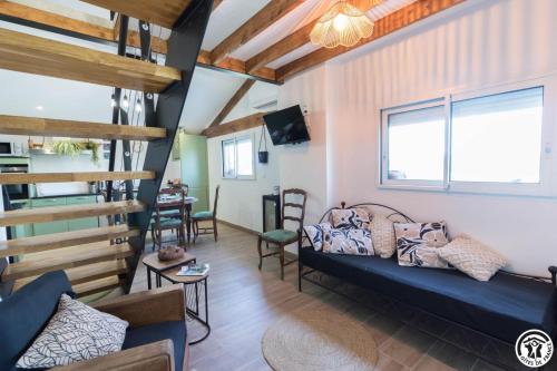 a living room with a couch and a table at La busquette in Villaudric