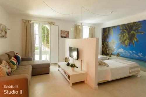 a living room with a bed and a couch at Akisol Vilamoura Gold in Vilamoura