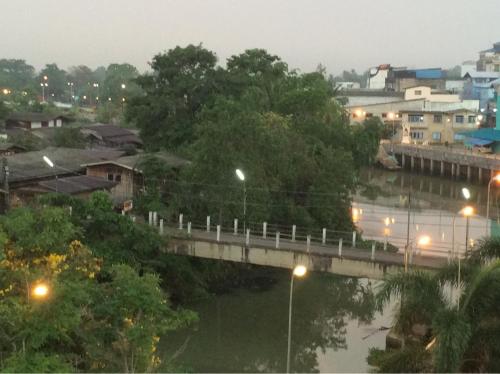 a bridge over a river next to a city at Panatara Chumphon in Chumphon