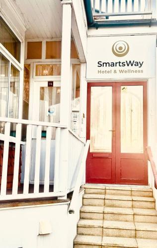 a red door on the front of a building at SmartsWay Hotel & Wellness in Eastbourne