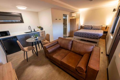 a living room with a couch and a bed at Oasis Newman in Newman